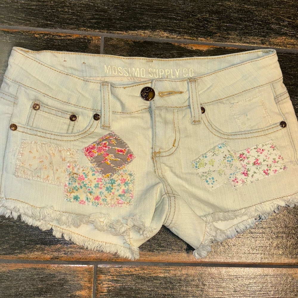 White jean shorts with cute buttons and patterns